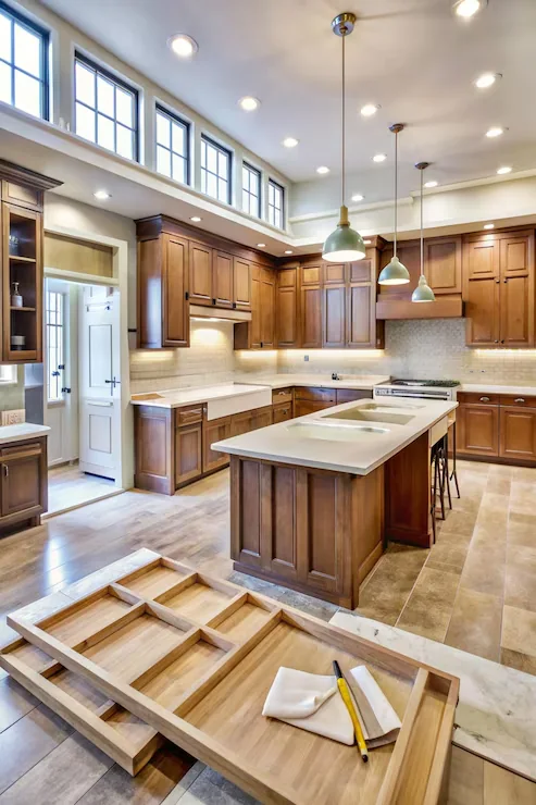 Warm cherry wood custom kitchen with clerestory windows, white quartz island and drawer organizer